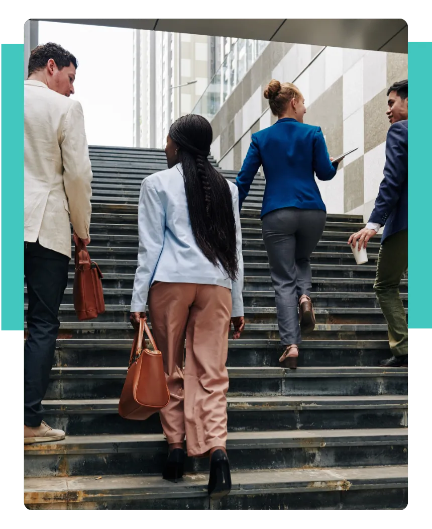 Four people talking while going up the stairs, representing continuous improvement