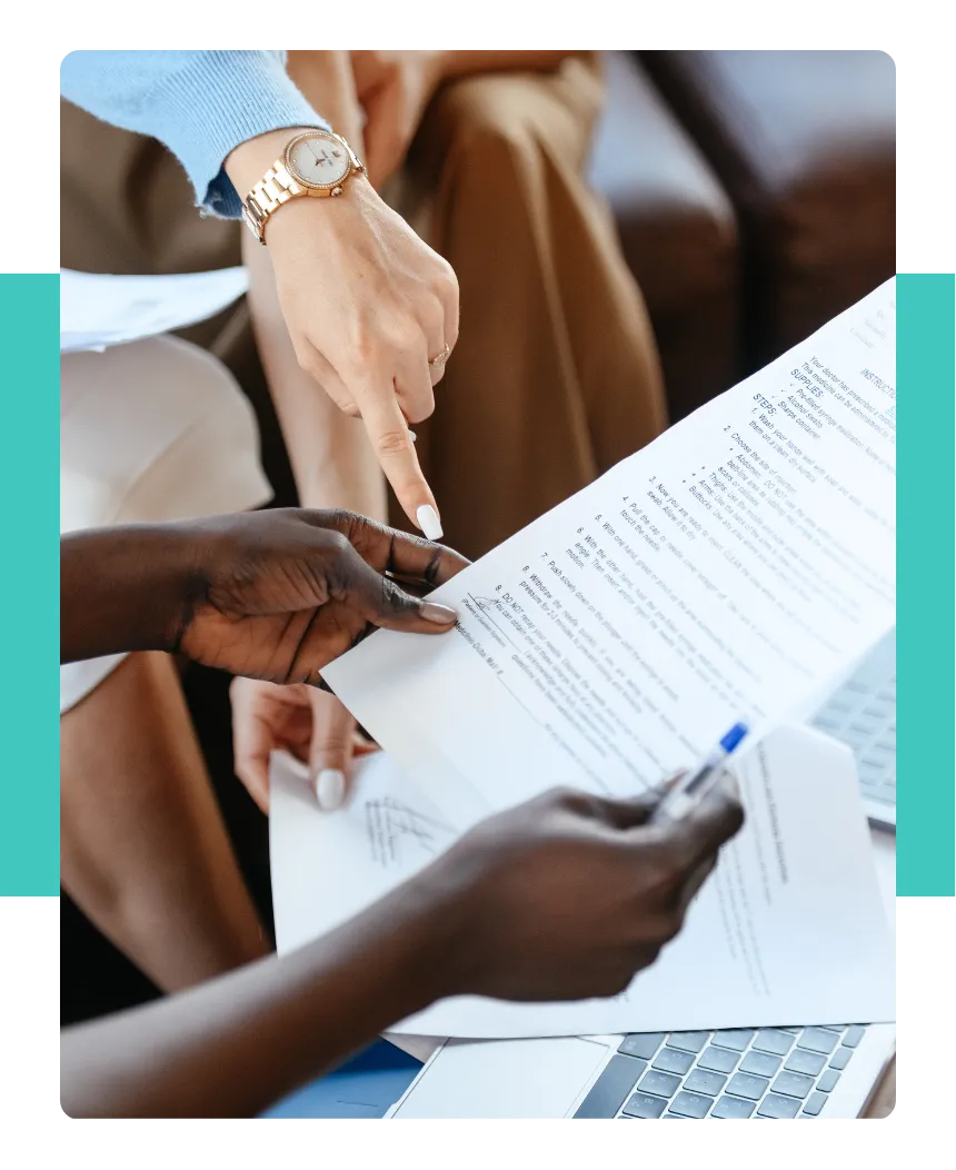 A close-up shot of people reviewing documents and reports